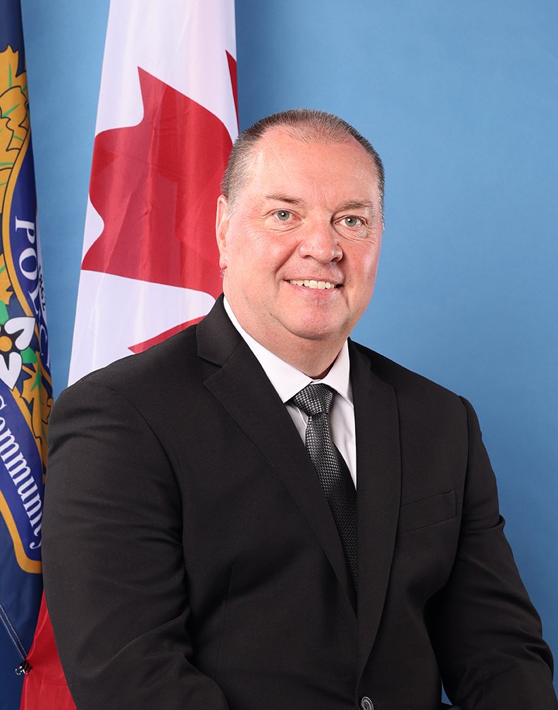 portrait of Daryl Stevenson in front of a flag