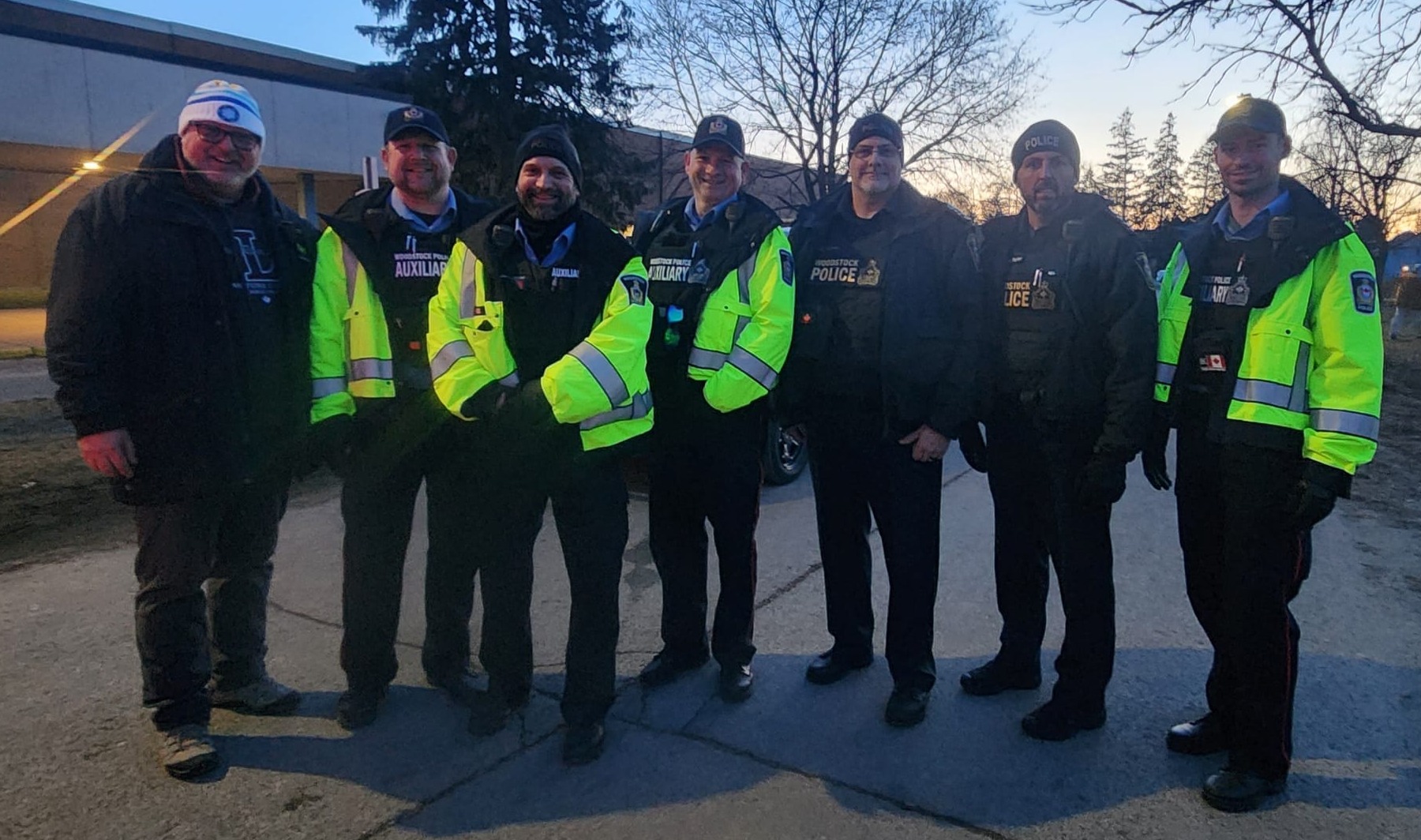 Four Auxiliary standing with the chief of police, inspector and mayor