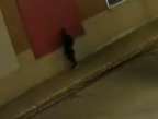 Male suspect dressed in black outside building