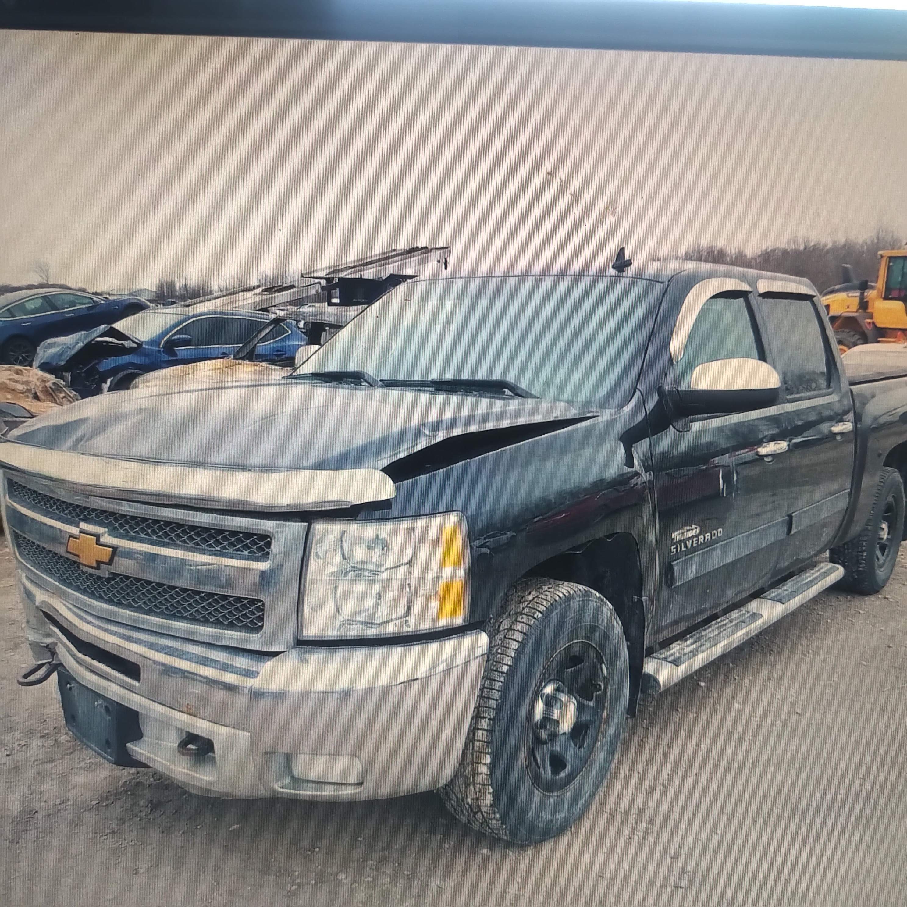 front driver's side of black 2012 Chevrolet Silverado pick up truck with damaged hood